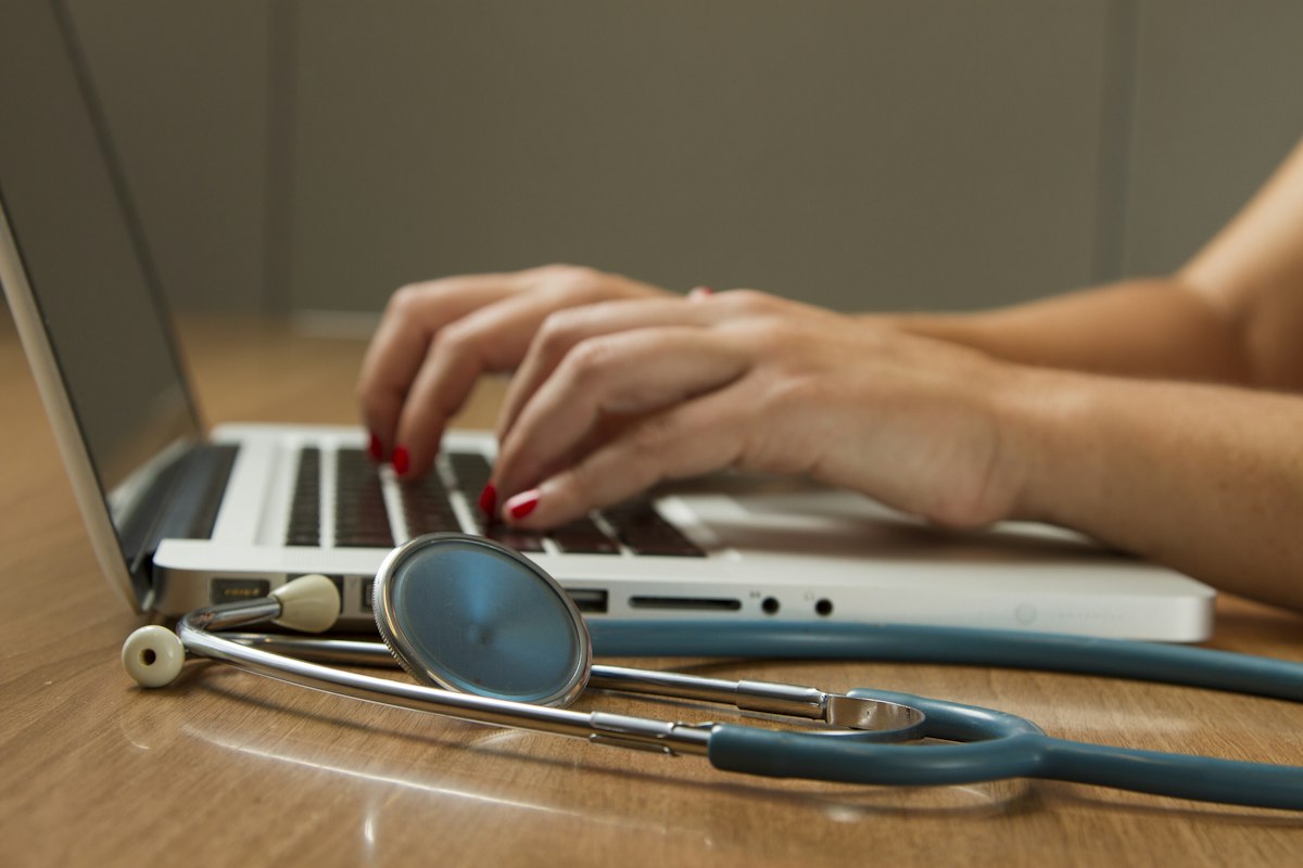 Clinicians reviewing a telemedicine platform on a tablet